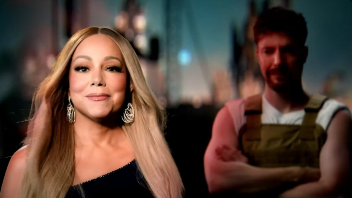 Mariah Carey em destaque, usando vestido preto de um ombro só e brincos brilhantes, com MrBeast desfocado ao fundo, vestindo colete marrom e camiseta branca, em cena do videoclipe Type Dangerous.