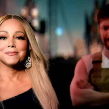 Mariah Carey em destaque, usando vestido preto de um ombro só e brincos brilhantes, com MrBeast desfocado ao fundo, vestindo colete marrom e camiseta branca, em cena do videoclipe Type Dangerous.